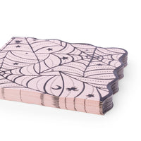 Stack of folded pink spiderweb Halloween napkins showing the wavy edge.