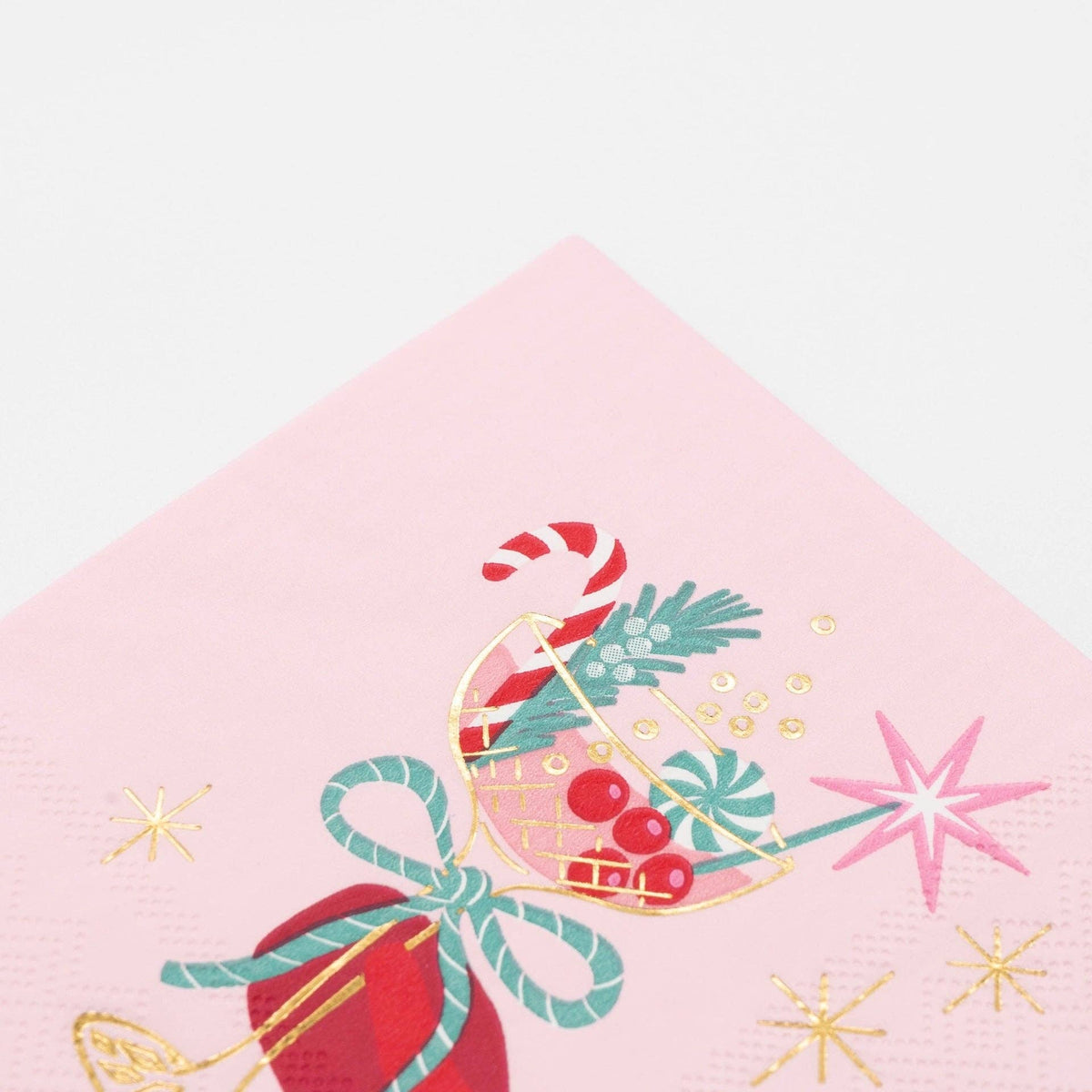 Front-facing studio shot of the pink square paper cocktail napkin displaying the full retro holiday drink illustration.