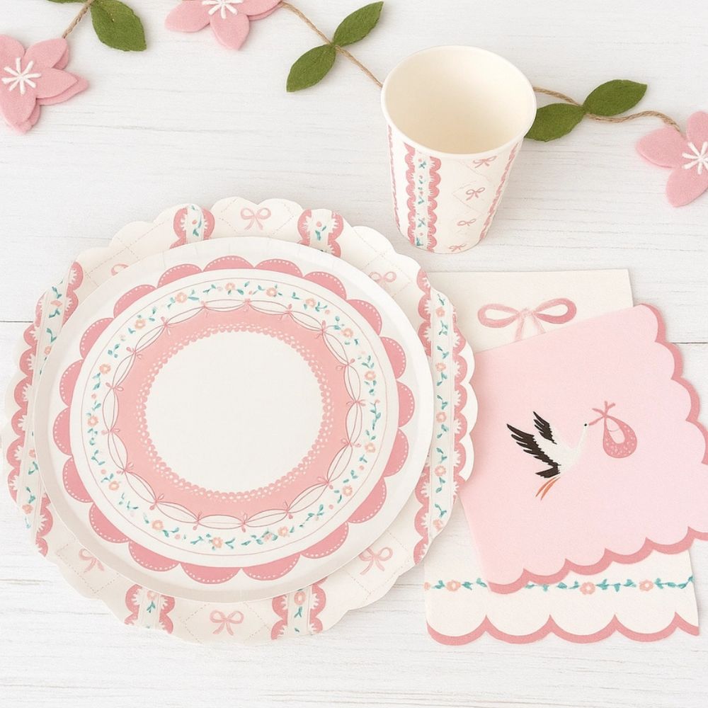 Complete place setting with stork napkin, pink lace plate, and matching cup
