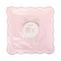 Top-down view of unopened Pink Striped Bow Square Paper Plates package showing both designs and the My Mind's Eye paper goods label confirming 8 plates and 2 designs