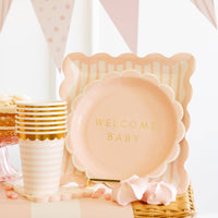 Scalloped square pink plates paired with dessert and cups