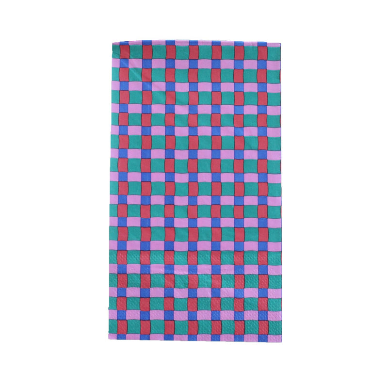 Top-down studio shot of a rectangular paper guest towel featuring a modern woven checkered pattern in pink, teal, and red.