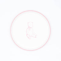 Pink teddy bear paper dessert plate, white plate with a pink rim and a sketched sitting bear