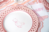 Pink teddy bear paper plate with a pink gingham BABY napkin and pink fork on a wavy pink placemat