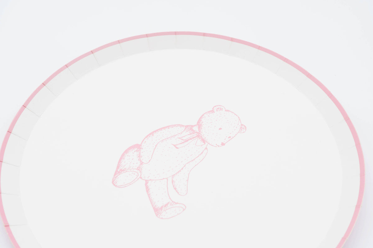 Close crop of a pink teddy bear paper plate showing the sketched bear and the pink scalloped rim