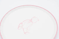 Close crop of a pink teddy bear paper plate showing the sketched bear and the pink scalloped rim