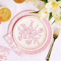 Pink toile dessert plate styled on table with flowers and drinks.