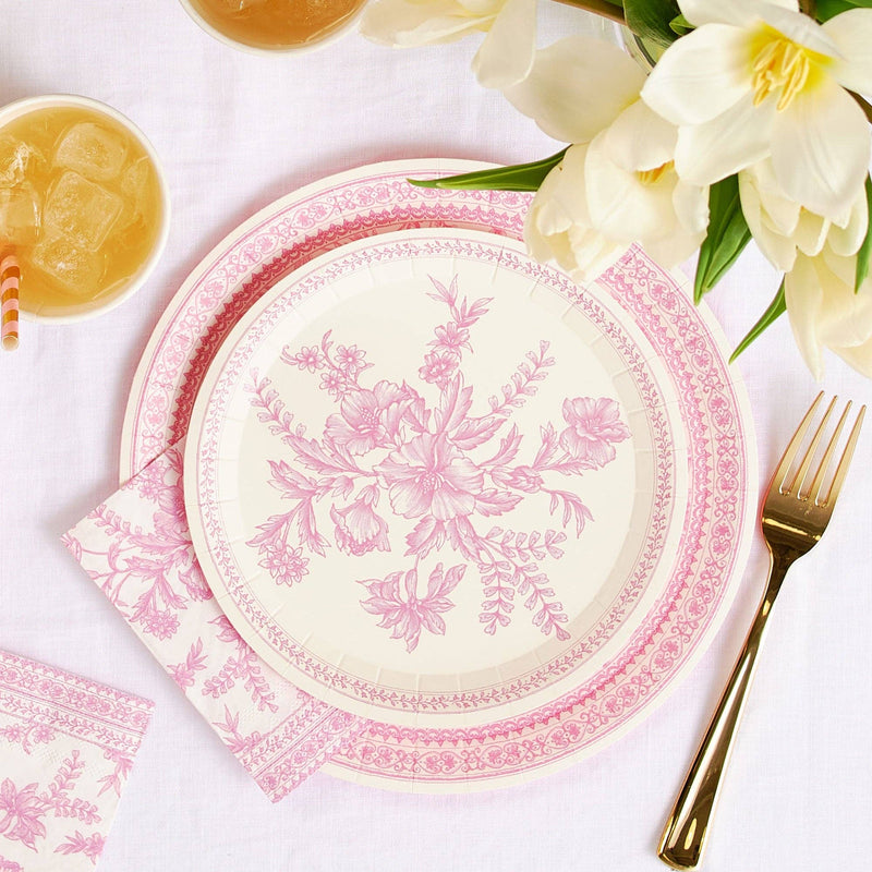 Pink toile dessert plate styled on table with flowers and drinks.