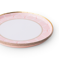 Stack of pink trellis small plates with gold rim detail