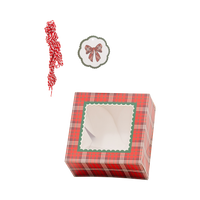 Red tartan plaid cookie box with green scalloped window, bow gift tag, and red and white striped twine
