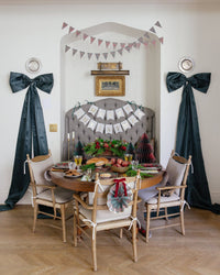 Plaid pennant banner styled above a holiday party table