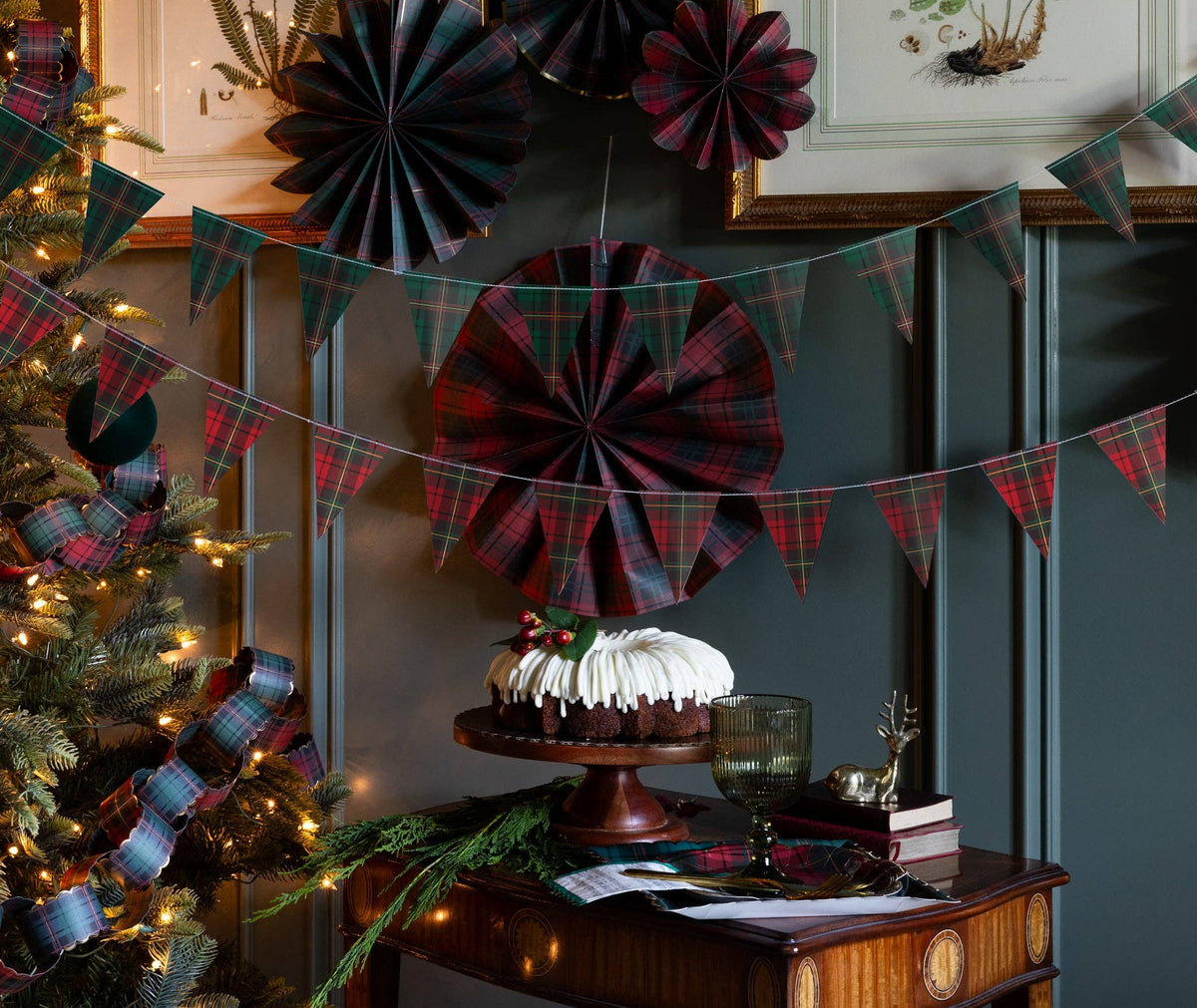 Plaid pennant banner styled on a wall with paper fans
