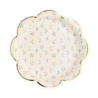 A single white paper plate with a dainty wildflower pattern and a gold-foiled scalloped edge, styled for an English garden theme.