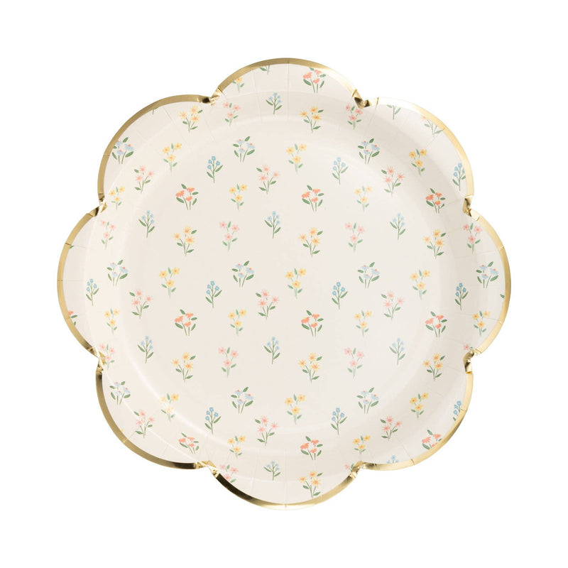 A single white paper plate with a dainty wildflower pattern and a gold-foiled scalloped edge, styled for an English garden theme.