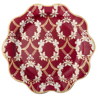 Pomegranate red dinner plate with an ornate gold floral Rococo pattern and scalloped edge, shown top-down