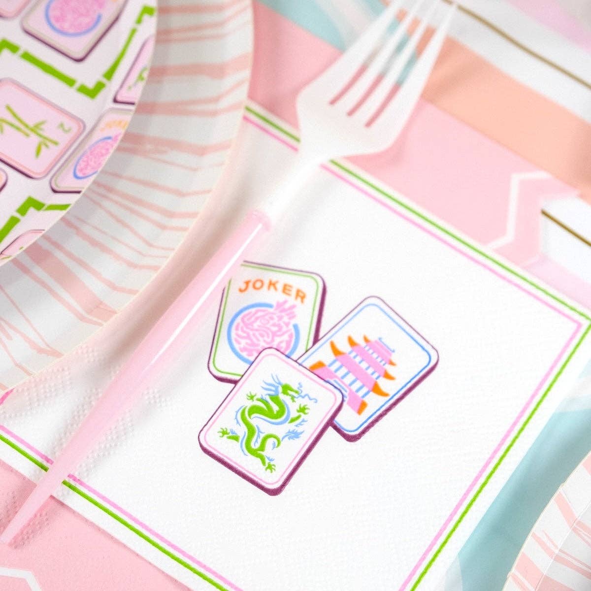 A Mahjong Cocktail Napkin styled with a pink fork as part of a Grandmillennial Table Decor setup.
