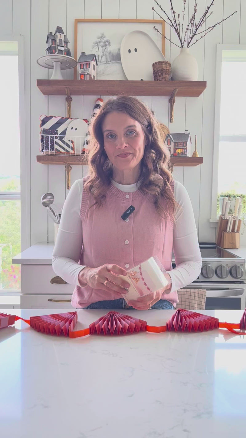 How to hang and style the pink-and-orange fan halloween banner—pre-strung pink bunting banner for mantels, dessert tables, and photo backdrops.