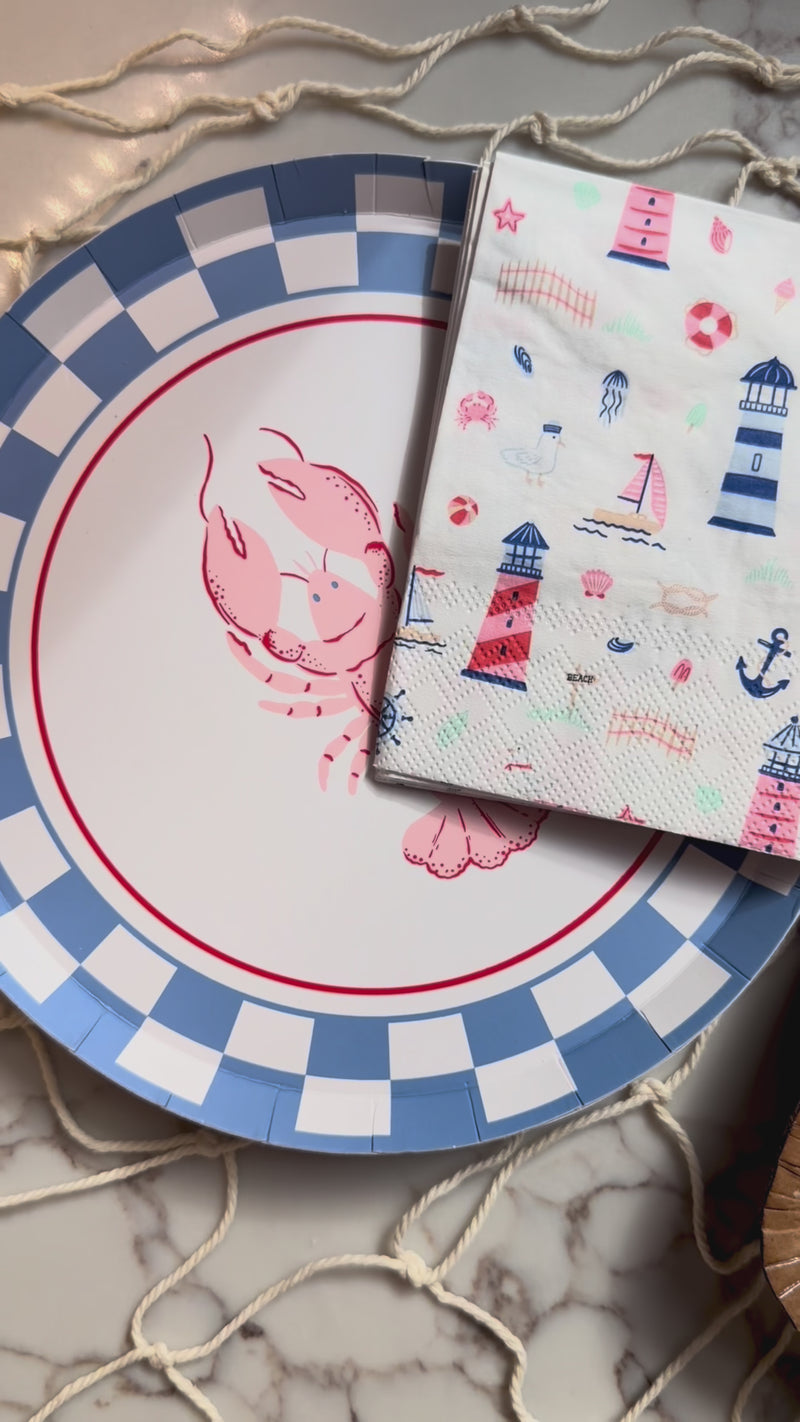 Seaside products like lobster plates and seaside napkins along with a lobster themed dessert.