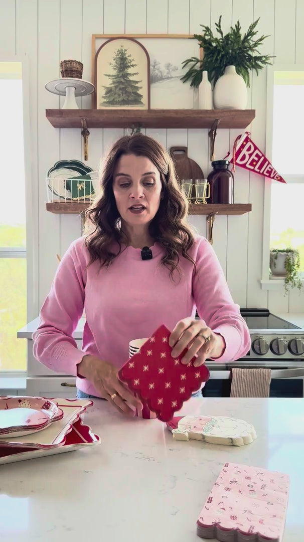 Video showing 12 oz pink and red striped Christmas party cups stacked together for holiday drinks