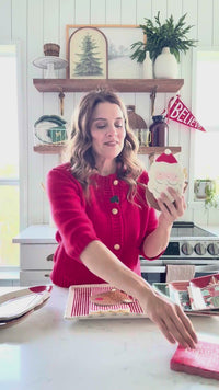 Video showing red Merry Christmas cocktail napkins displayed on a holiday table