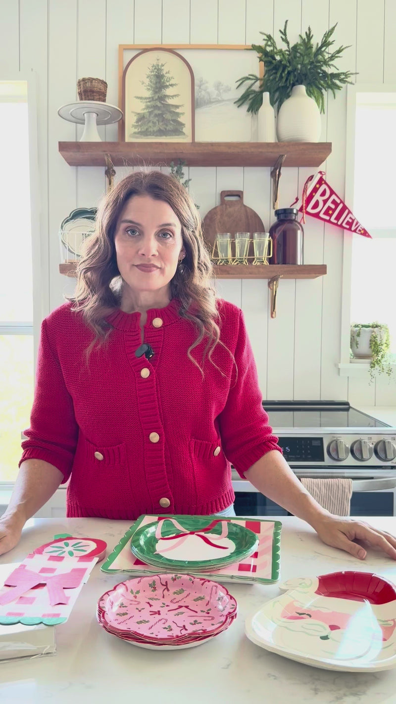 Video demonstrating how to assemble the bow napkin ring set and wrap it around the red plaid napkins for a finished gingham party supplies place setting.