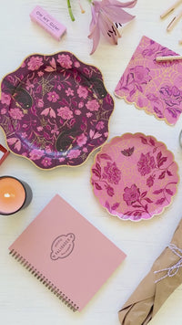 Pink Halloween cake plates with gold spider web, roses, gothic moth, and scalloped gold foil edges styled for an elegant Halloween dessert table.