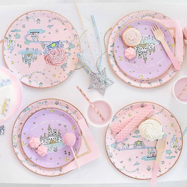 Princess dessert plates holding cupcakes on fairytale party table.