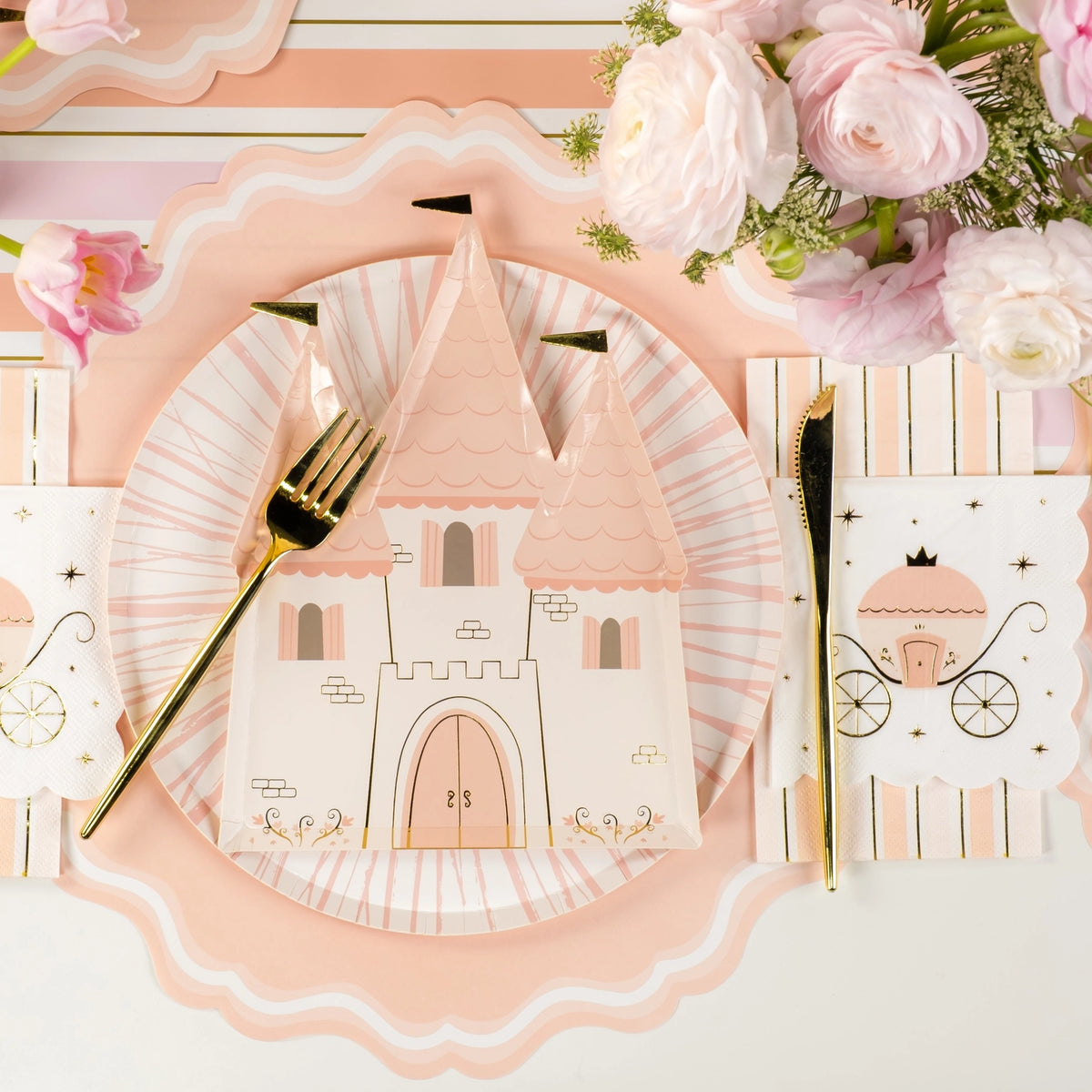 Overhead place setting featuring castle plate, carriage napkin, and florals.