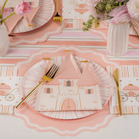 Blush castle plate layered on pink charger with gold flatware—easy decorations for a princess party.