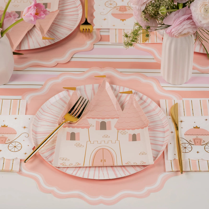 Blush castle plate layered on pink charger with gold flatware—easy decorations for a princess party.