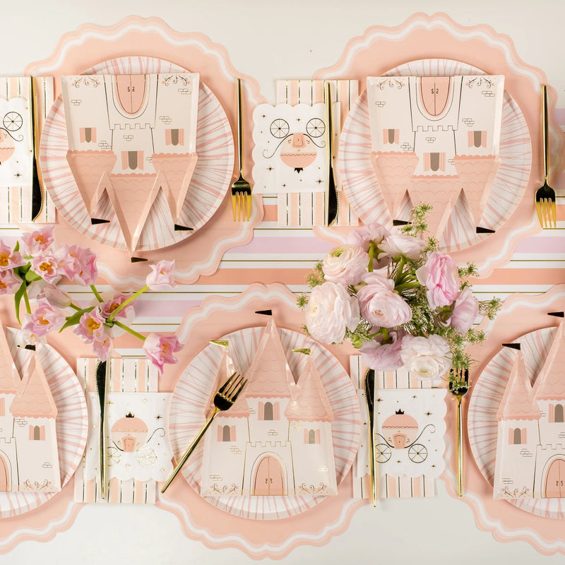 Runner view: full royal tablescape repeating castle plates down the table.