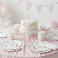 Full party table setup with a ribbon cake and princess place settings
