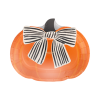 Angled view of the orange pumpkin plate showing the die-cut shape, striped bow detail, and dark stem in a clear wrap. 