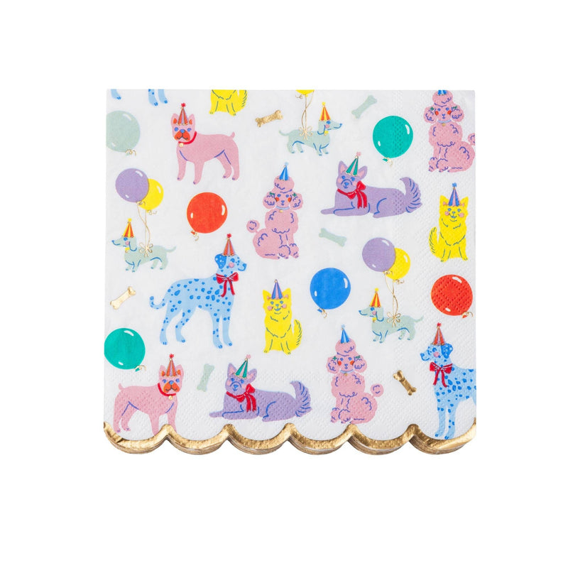 Single square Puppy Dog party napkin, flat-lay, with illustrated pups in party hats, balloons and a gold-foil scalloped edge on white.