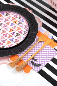 Lavender checkered bat napkin layered with an orange scalloped napkin and gold fork and knife