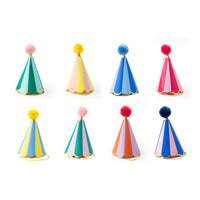 Eight rainbow stripe cone party hats with gold foil trim and pom toppers