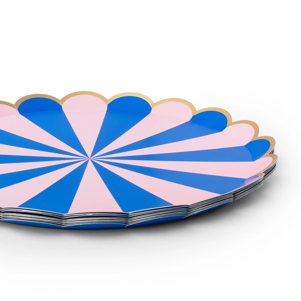Close-up of a pink and blue stripe scalloped paper party plate