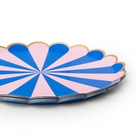 Close-up of a pink and blue stripe scalloped paper party plate