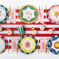 Rainbow stripe scalloped plates styled on a colorful party table setting