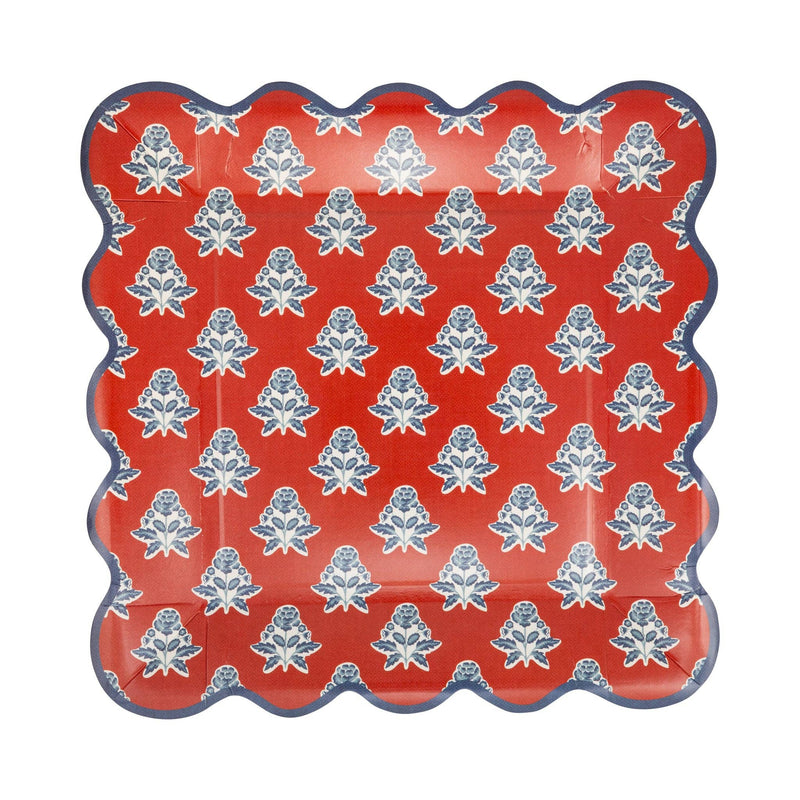 Overhead view of red block print floral scalloped paper plate showing full repeating blue and cream floral pattern with navy scalloped border
