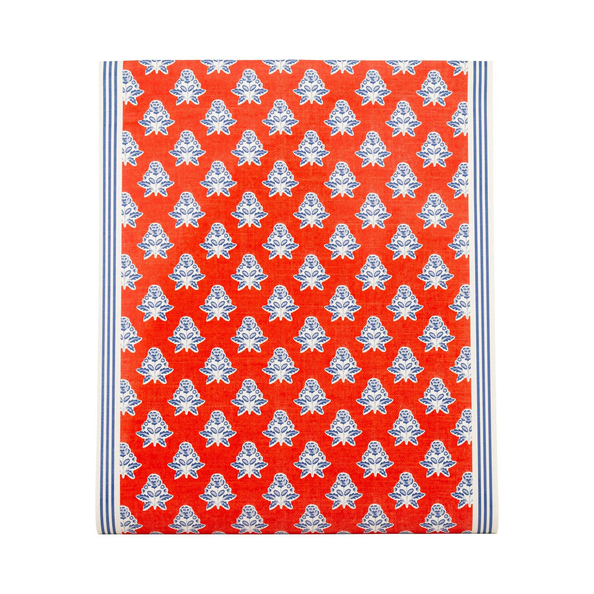 Flat lay of red block print floral paper table runner showing full pattern with navy ticking stripe border