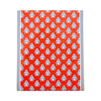 Flat lay of red block print floral paper table runner showing full pattern with navy ticking stripe border