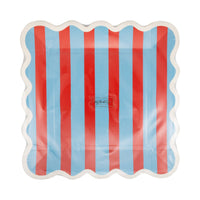Front of red and blue striped square scalloped paper plate showing vertical red and blue stripes with white scalloped edge