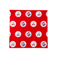 Single red cherry and floral polka dot luncheon napkin flat lay on white background showing full pattern of white circles with cherry and flower motifs