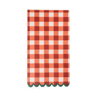 Large-scale red and cream gingham paper dinner napkin with a green scalloped edge, folded, on a white background.