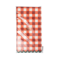 Stack of red gingham dinner napkins showing the green scalloped edges and the oversized check.