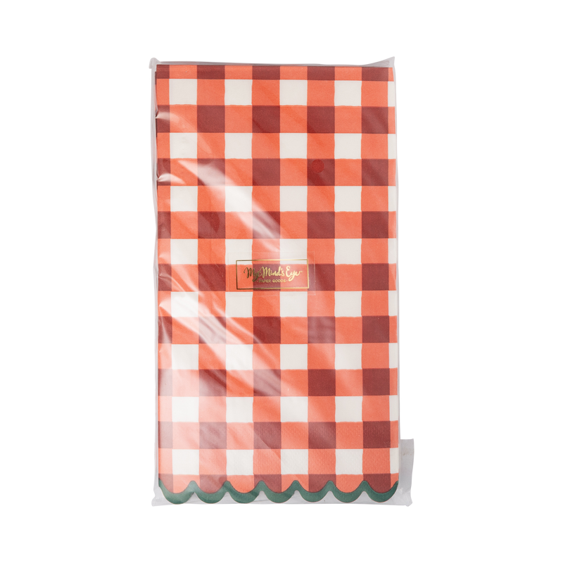 Stack of red gingham dinner napkins showing the green scalloped edges and the oversized check.