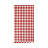Folded red and cream gingham paper dinner napkin with wavy red scalloped edges on a white background