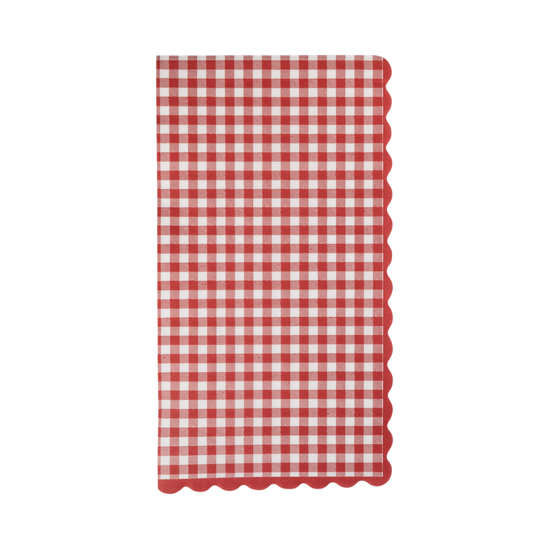 Folded red and cream gingham paper dinner napkin with wavy red scalloped edges on a white background