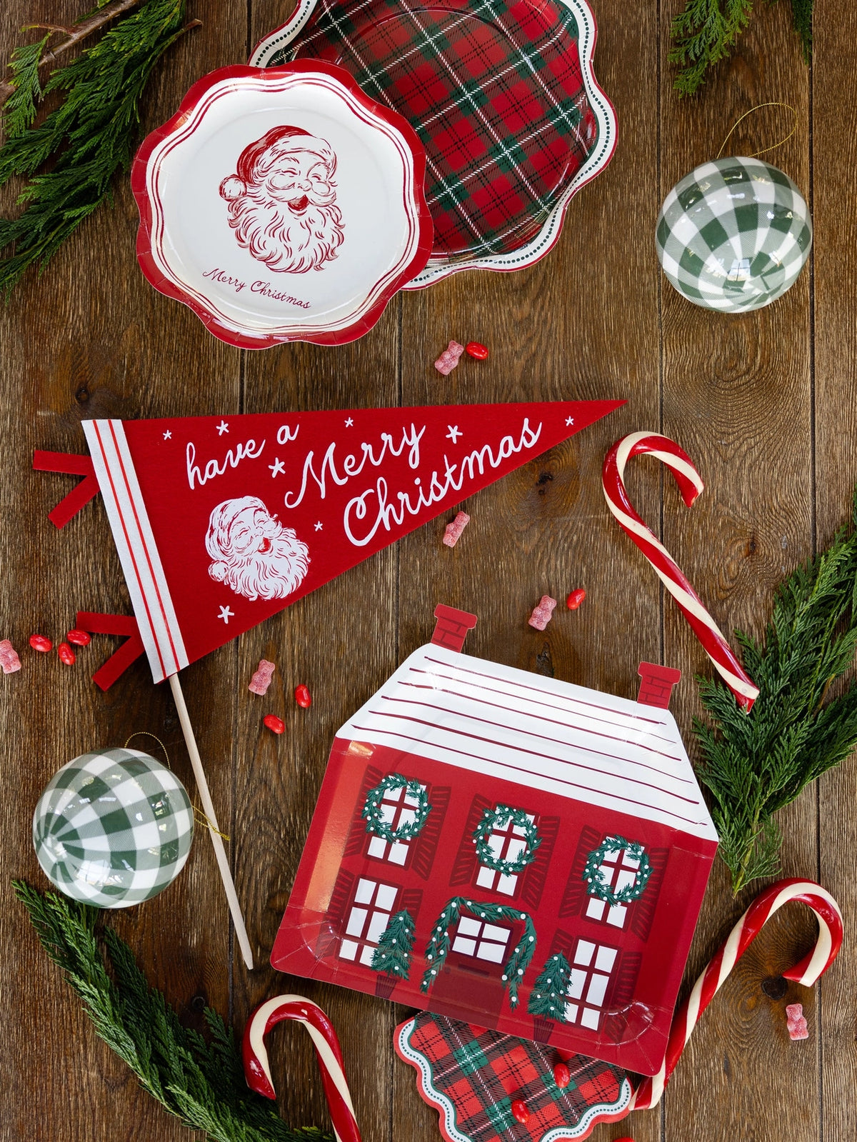 Red house-shaped plates styled with a Santa pennant and candy canes